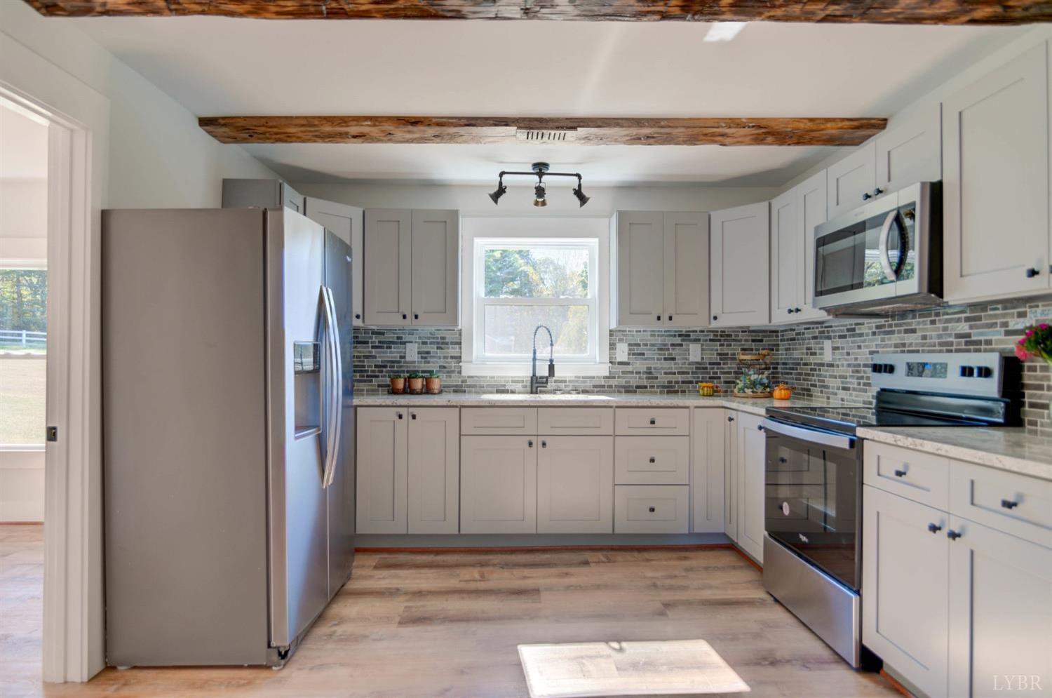 234 Baileys Sawmill Road Amherst, VA 24521 - Photo 15 of 32 a kitchen with granite countertop a sink stainless steel appliances and cabinets