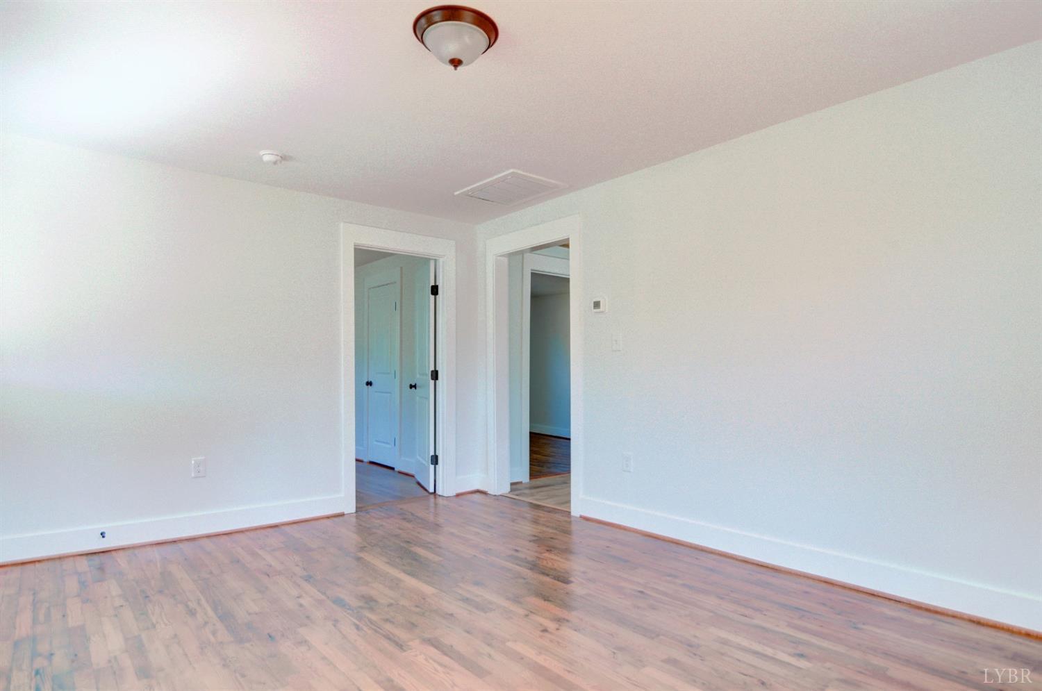 234 Baileys Sawmill Road Amherst, VA 24521 - Photo 8 of 32 an empty room with wooden floor