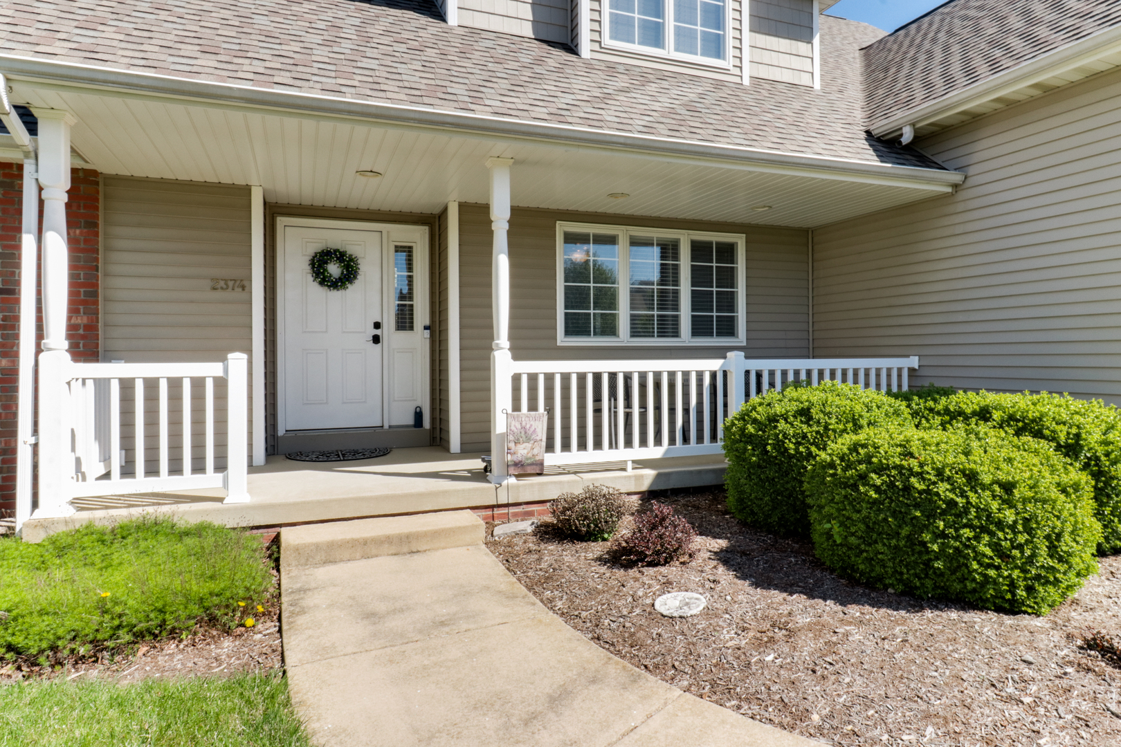 2374 Heather Ridge Drive Normal, IL 61761 - Photo 2 of 31 a front view of a house with a garden