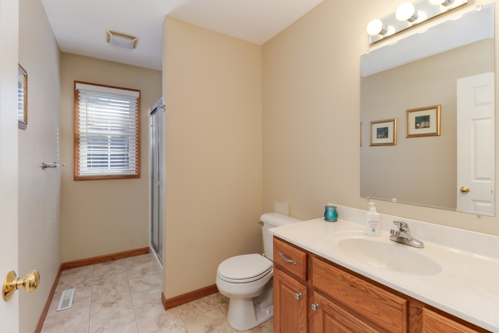 2374 Heather Ridge Drive Normal, IL 61761 - Photo 23 of 31 a bathroom with a granite countertop toilet a sink and a mirror