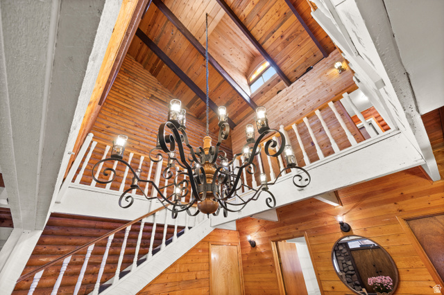 4725 Pine Ridge Road Evanston, UT 82930 - Photo 13 of 82 Vaulted wood-paneled ceilings featuring exposed beams and an iron chandelier