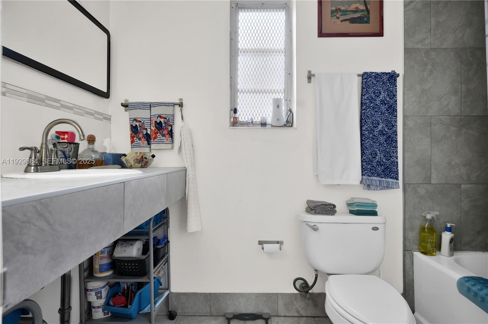 512 Southwest 21st Avenue Miami, FL 33135 - Photo 24 of 33 a bathroom with a toilet a sink and a mirror