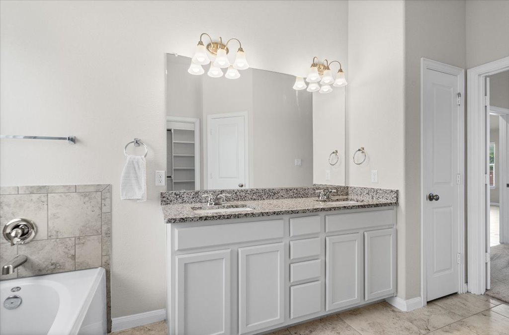 132 Vino Rossi Road Georgetown, TX 78628 - Photo 17 of 35 Double Vanity with raised height cabinets and granite counters