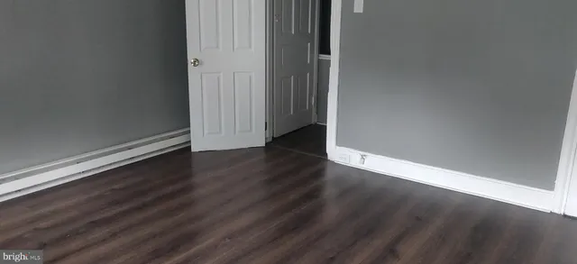 an empty room with wooden floor