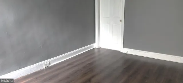 an empty room with wooden floor
