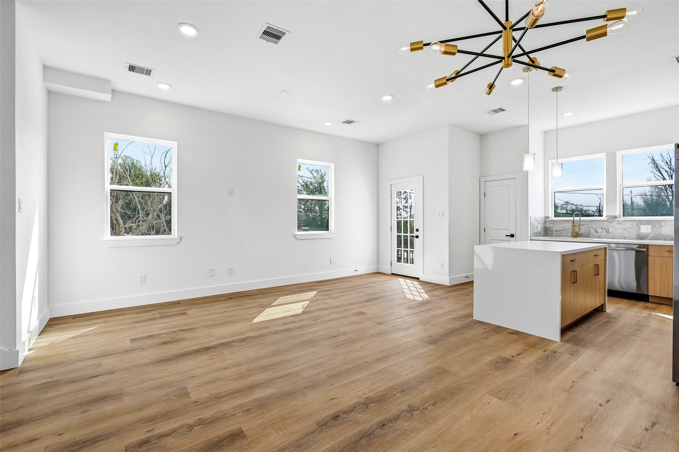 4209 Allston Street Houston, TX 77018 - Photo 11 of 31 a view of a kitchen with a sink dishwasher a refrigerator with wooden floor and a chandelier