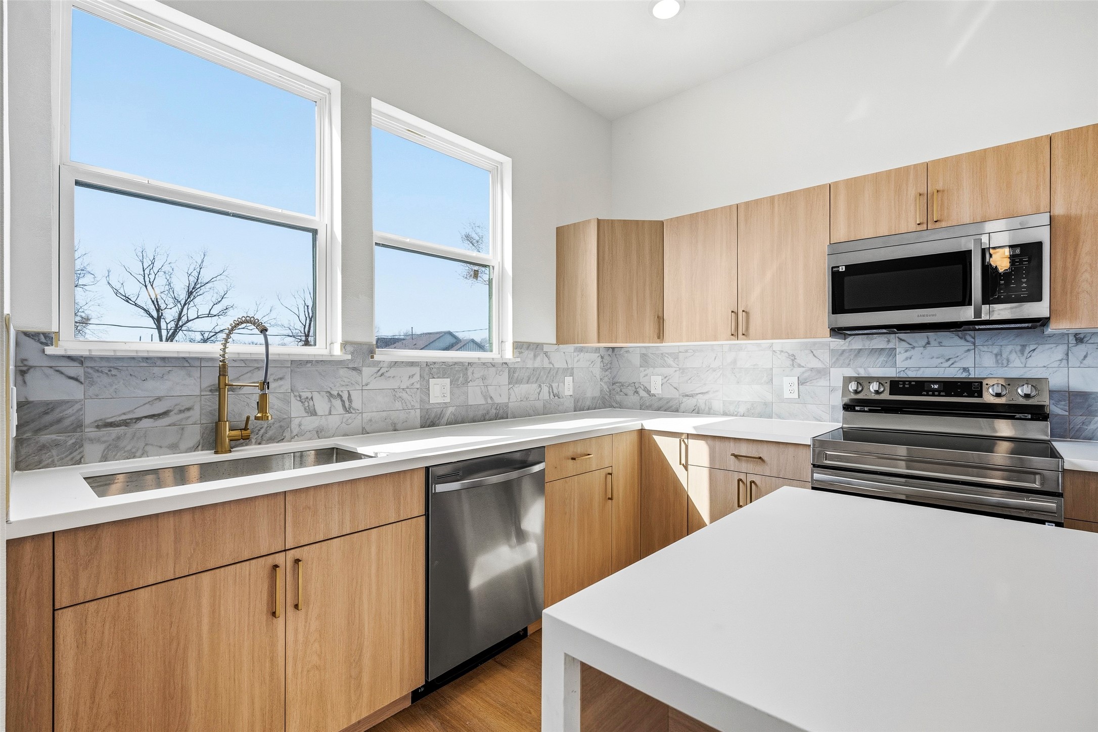 4209 Allston Street Houston, TX 77018 - Photo 13 of 31 a kitchen with a sink and a stove top oven with wooden floor