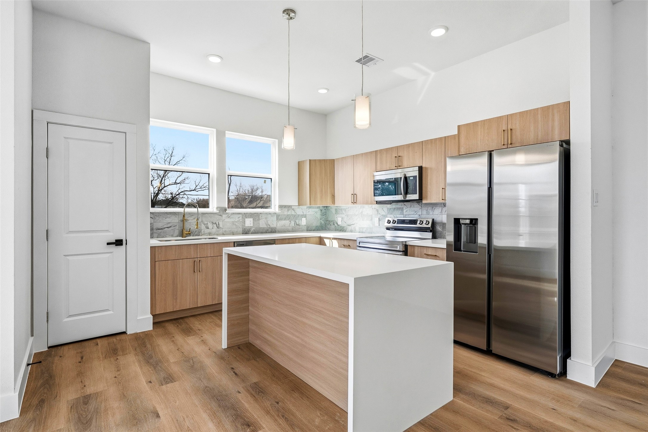4209 Allston Street Houston, TX 77018 - Photo 15 of 31 a kitchen with stainless steel appliances granite countertop a refrigerator a sink dishwasher a stove and white cabinets with wooden floor
