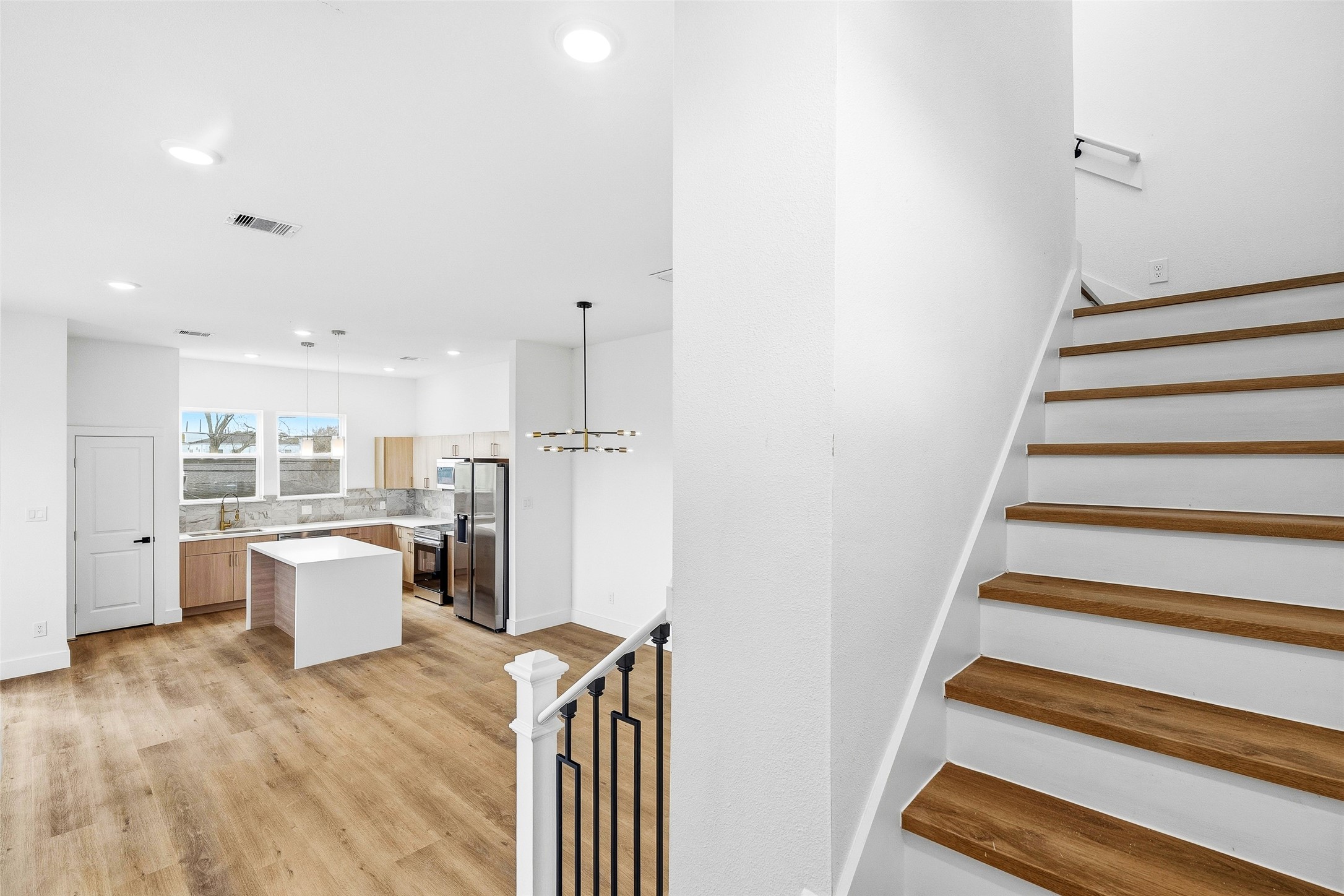 4209 Allston Street Houston, TX 77018 - Photo 19 of 31 a view of a kitchen with wooden floor and electronic appliances