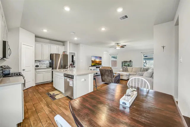 a kitchen with sink refrigerator and microwave