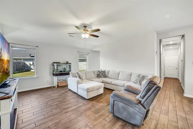 a living room with fireplace furniture and a flat screen tv