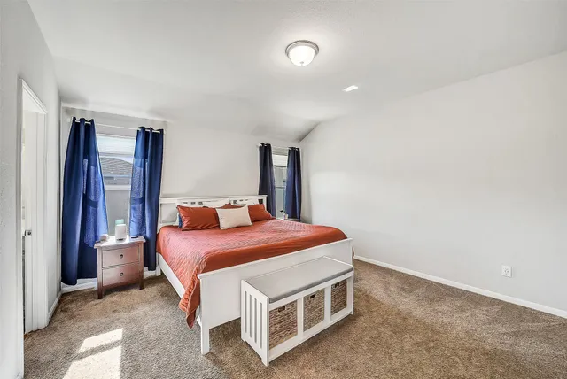 a room with a bed and a cabinets