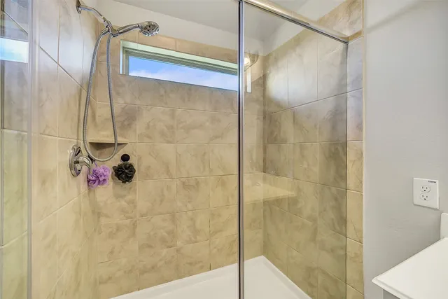 a bathroom with a glass shower door