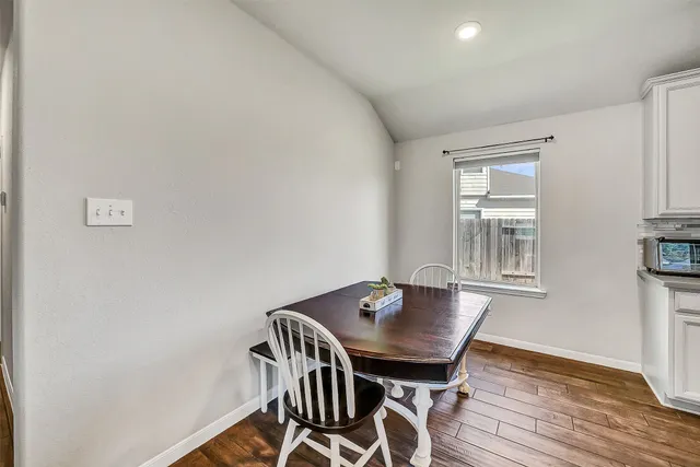 a view of a dining room with furniture and wooden floor