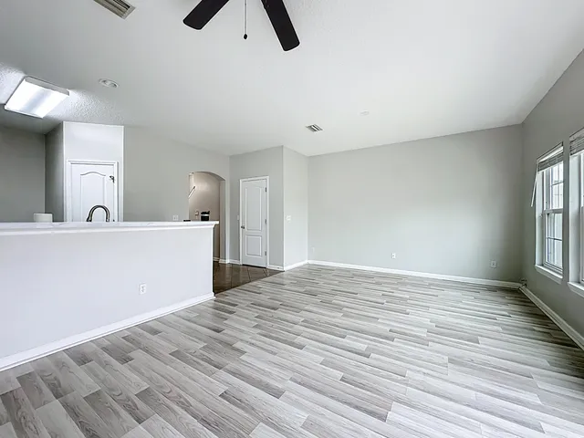 a view of a kitchen and an empty room