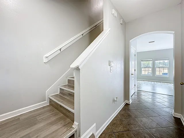 a view of an entryway with wooden floor and stairs