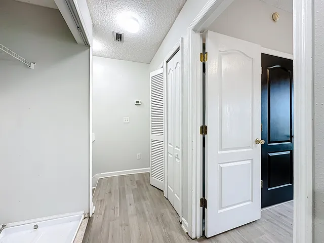 a view of hallway with wooden floor