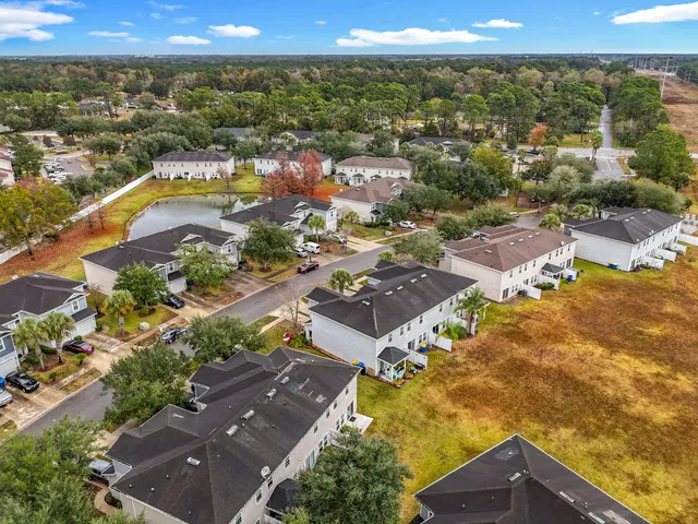 an aerial view of residential houses with outdoor space