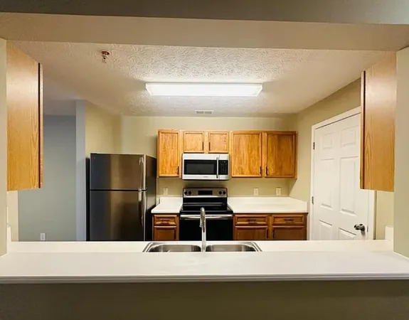 a kitchen with a refrigerator and a stove