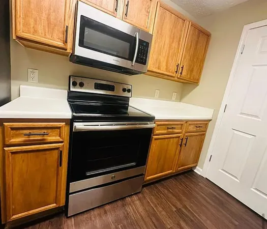 a kitchen with wooden floors and a stove top oven