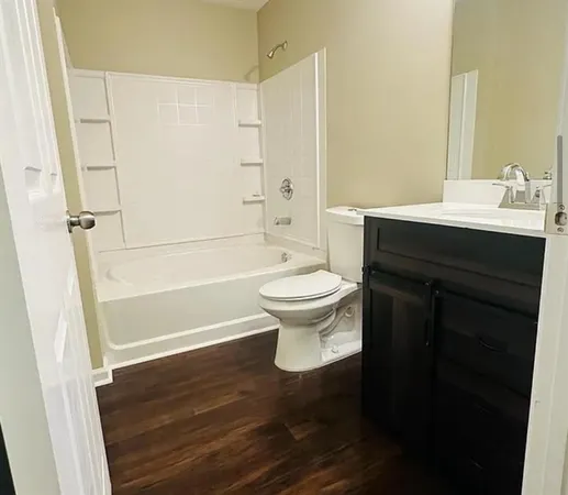 a bathroom with a sink a toilet a shower and a mirror