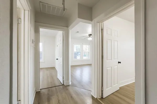 a view of a hallway with wooden floor