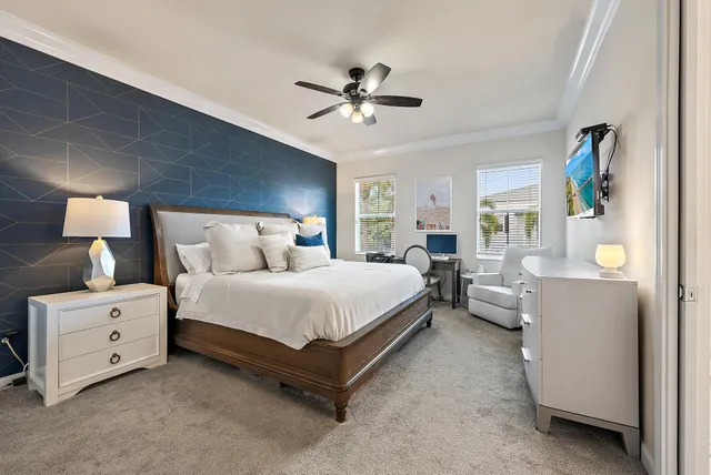 a spacious bedroom with a bed and a chandelier