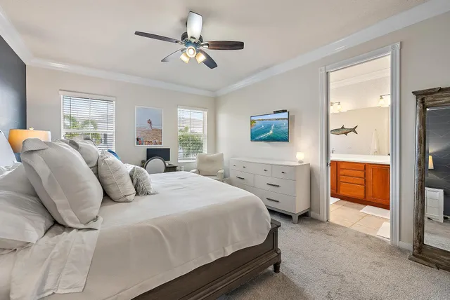 a spacious bedroom with a bed and a chandelier
