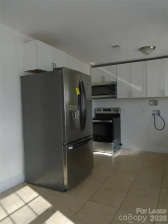 a kitchen with a refrigerator and a stove