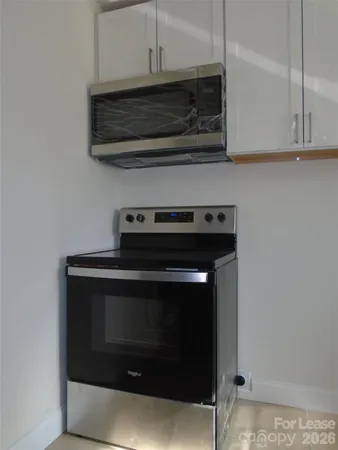 a stove top oven sitting inside of a kitchen