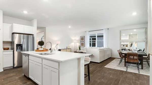 a kitchen that has a table and chairs in it