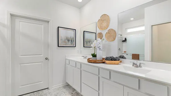 a bathroom with 2 sink and a mirror