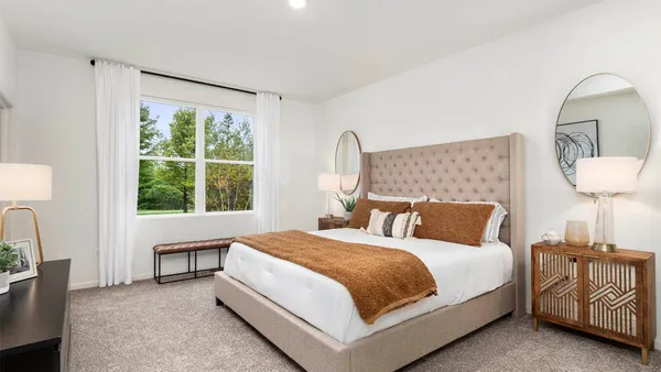 a bedroom with a bed a table and chair