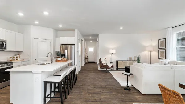 a large kitchen with a table and chairs