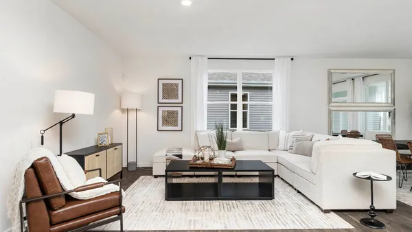 a living room with furniture and a lamp