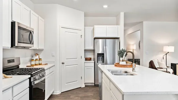 a kitchen with stainless steel appliances a sink stove and refrigerator