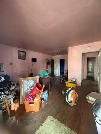 a bedroom with furniture and a wooden floor