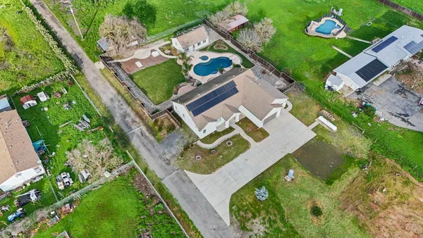 an aerial view of house with yard