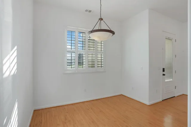 a bedroom with a large bed and windows