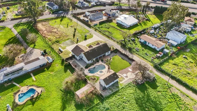 an aerial view of a house with a garden and swimming pool
