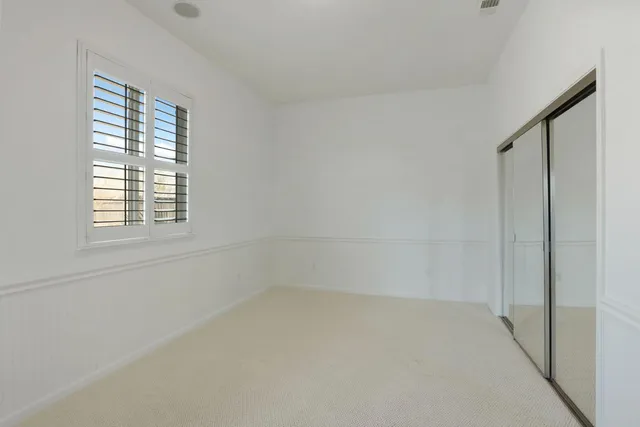 a bathroom with a double vanity sink toilet mirror and shower