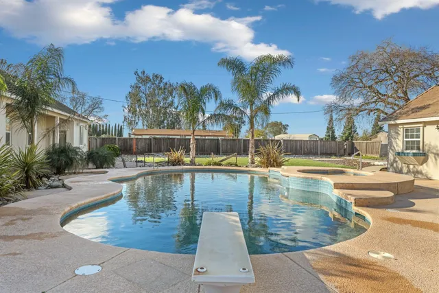 a view of a swimming pool with a patio