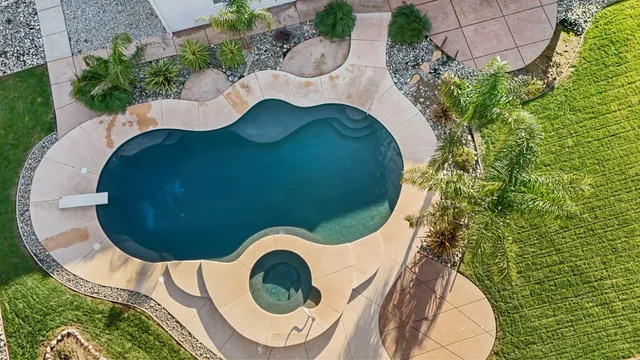 a view of a swimming pool with sitting area