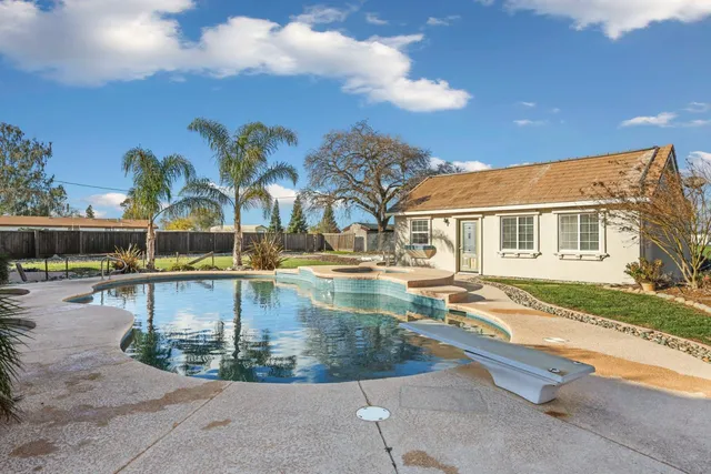 a view of a swimming pool with outdoor seating