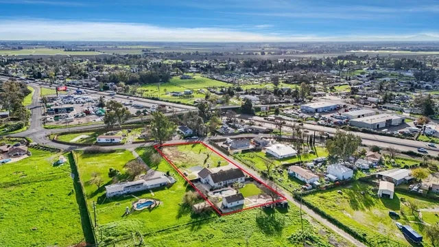 an aerial view of a house with a garden and trees