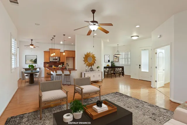 a view of empty room with wooden floor and ceiling fan