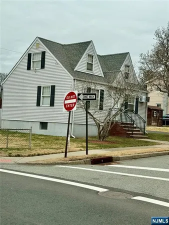 a view of a house with a backyard