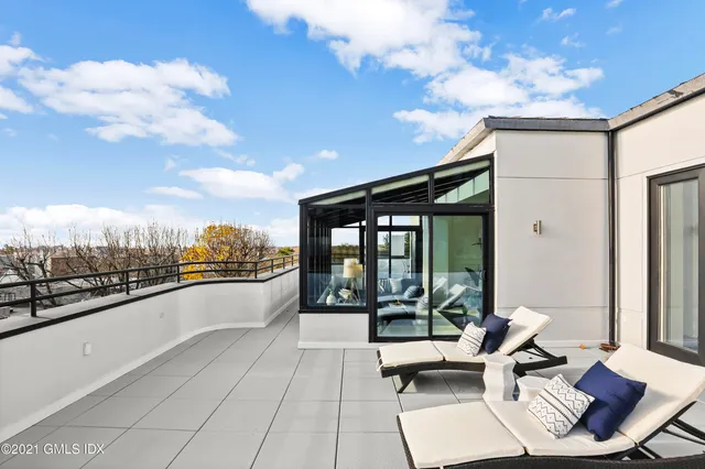 a terrace with outdoor seating and trees