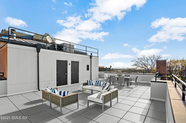 a view of a balcony with table and chairs