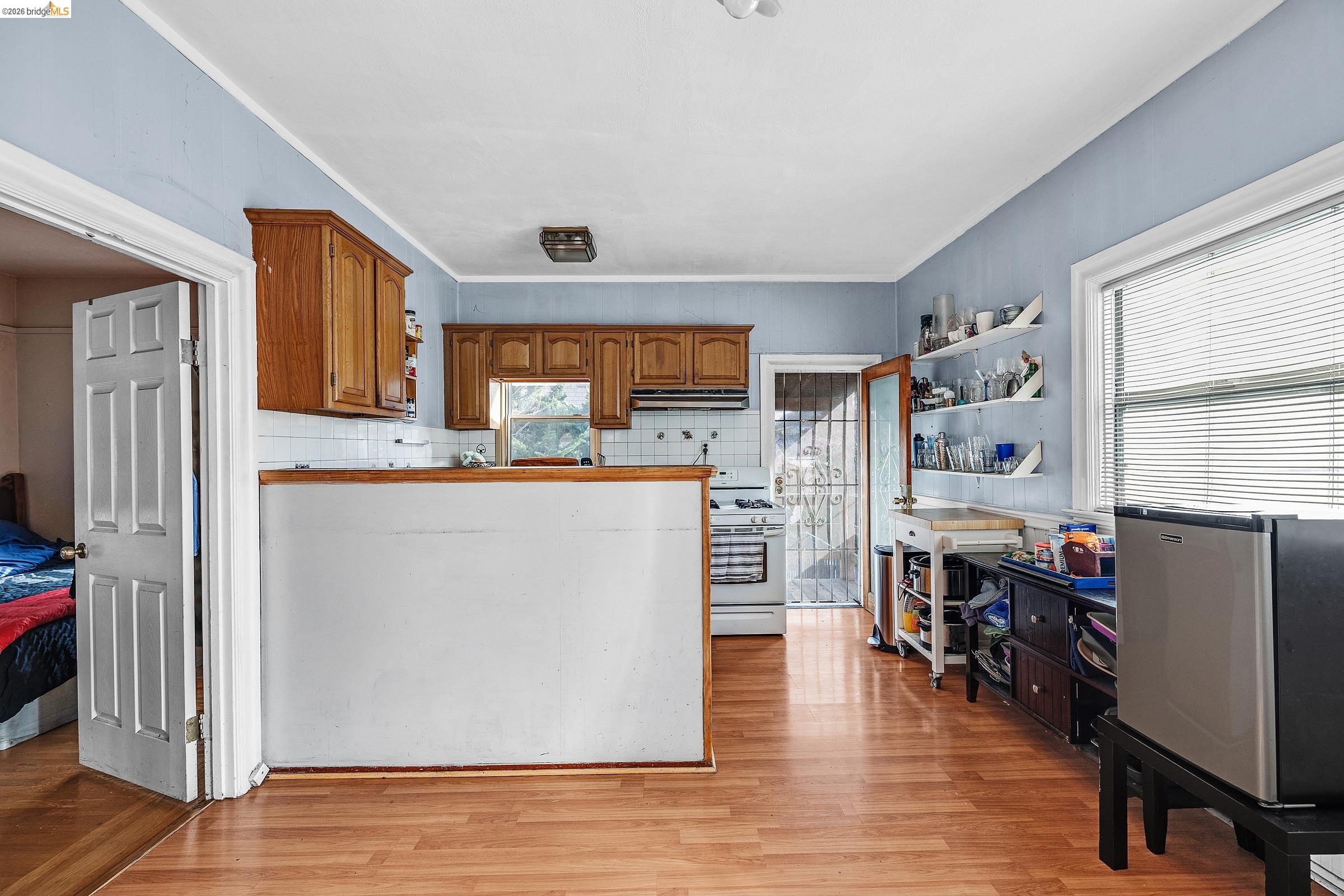 976 Park Street Alameda, CA 94501 - Photo 13 of 36 a kitchen with stainless steel appliances a refrigerator and a stove top oven